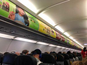 Overhead lockers were plastered with advertising.